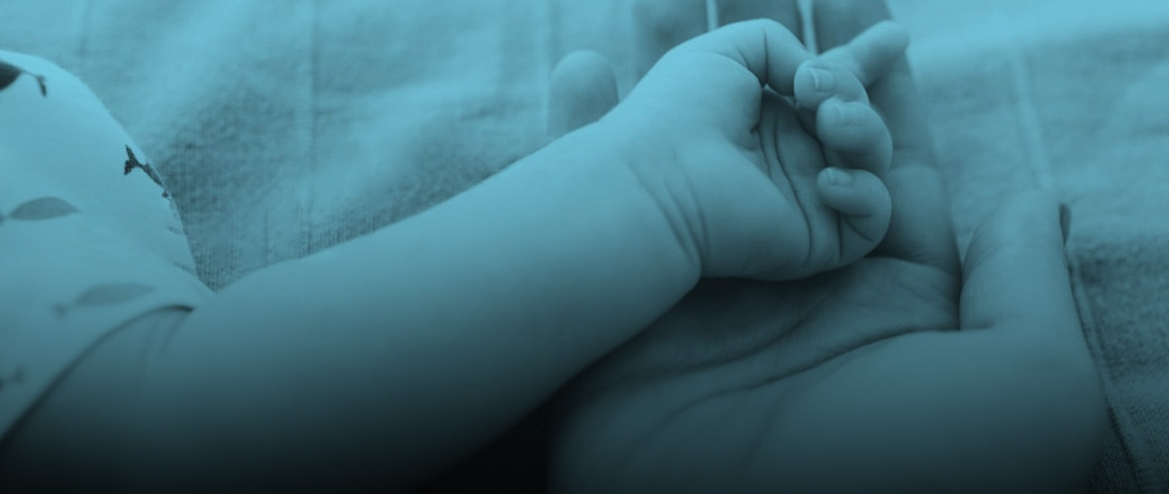A hand gently holds a baby's hand, accompanied by the text emphasizing the importance of a healthy baby.